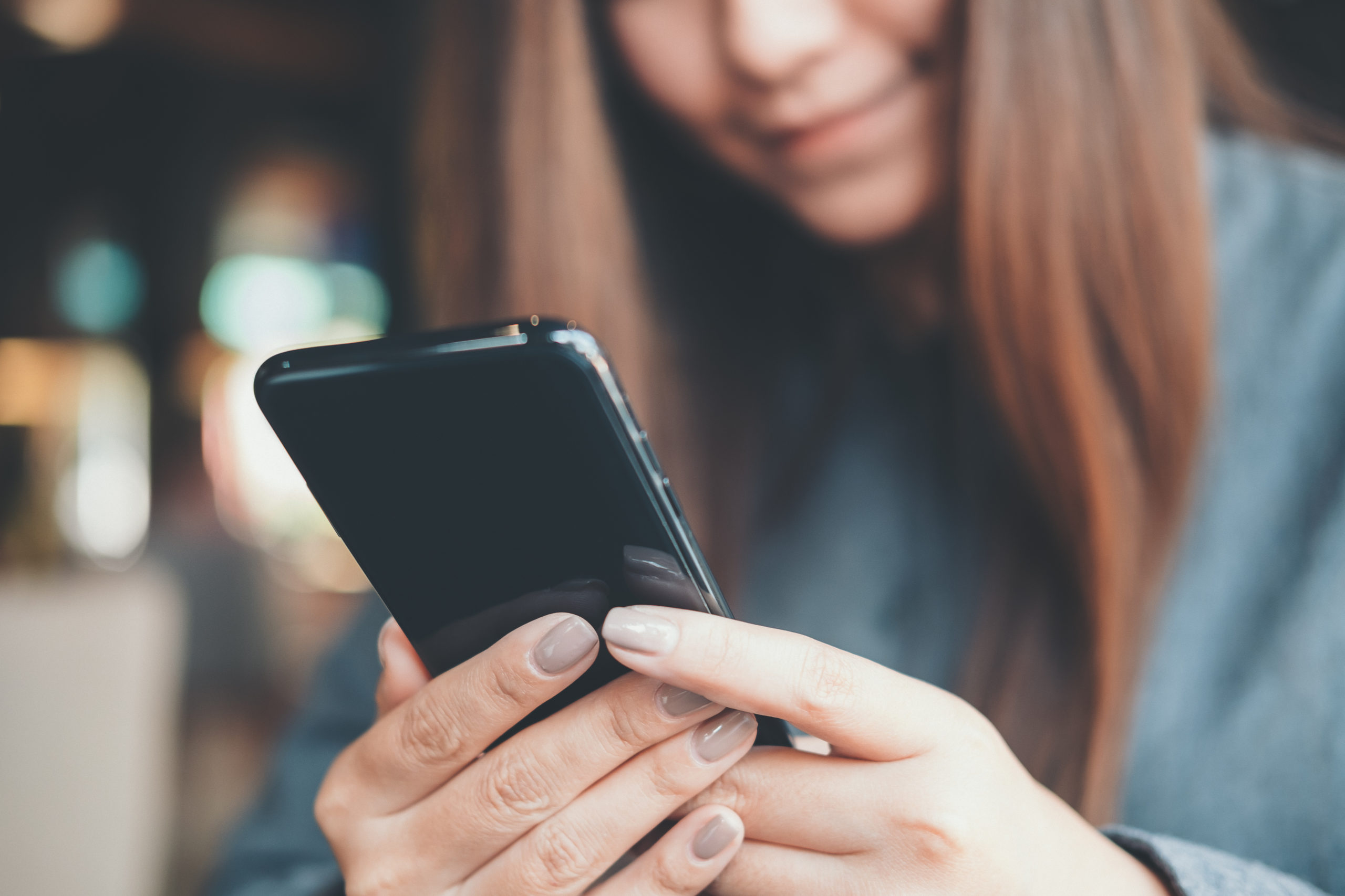 Woman checking phone while running errands